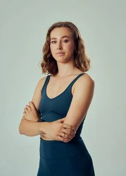 Three quarter portrait of young caucasian woman in sportswear looking at camera Stock Photos