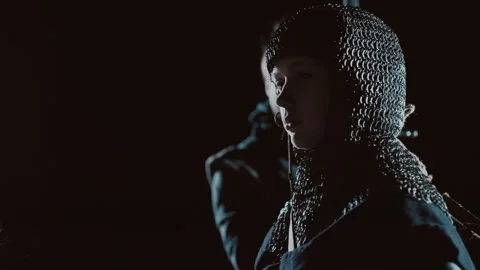 Three-quarter profile of person in studded leather jacket and chainmail Stock Footage 343687124