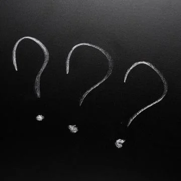 Three question marks on the blackboard Stock Photos