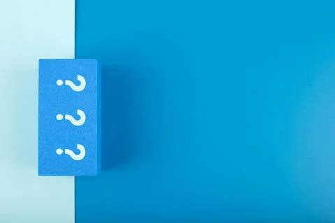 Three question marks on blue rectangle on monochromatic blue background with Stock Photos