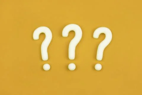 Three question marks on orange background. 3d model, mock-up of interrogation Stock Photos