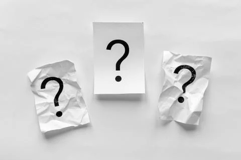 Three question marks on white paper Stock-Fotos