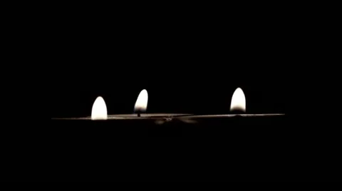 Three  quickly rotating burning candles Видео 19643579