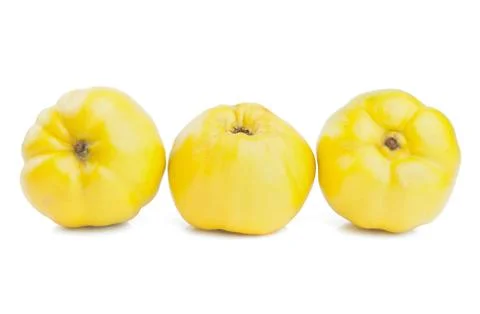 Three quinces on a white background Stock Photos