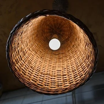 Three rattan chandeliers different forms on white brick wall background. Stra Stock Photos