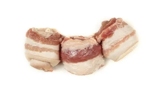 Three raw bacon rolls rolled into a tube. Raw meat with lard. Isolated Stock Photos