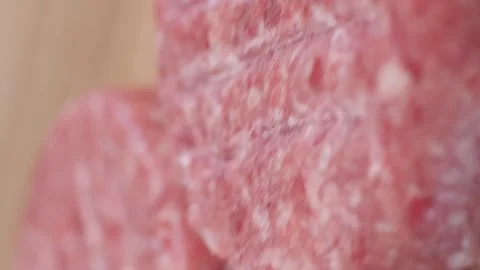 Three raw burger patties lying on a wooden board. Video stock 234009090