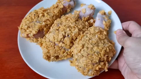 Three Raw Chicken Legs Coated with Crushed Nachos Stock Footage 161006095