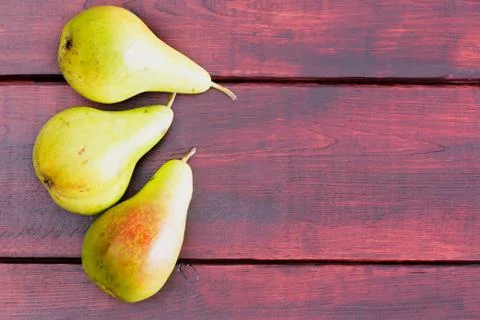 Three raw green pears on table Stock Photos