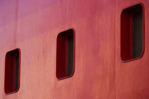 Three Rectangular Portholes On A Red Ship Hull Stock Photos