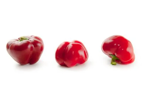 Three red bell pepper isolated on white background with clipping path. . Stock Photos