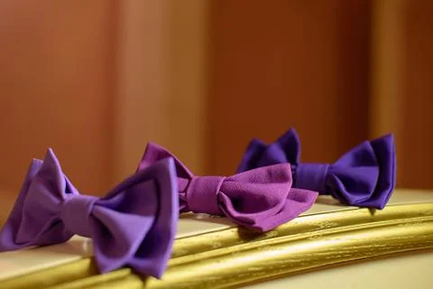 Three red bowtie on a yellow table Stock Photos