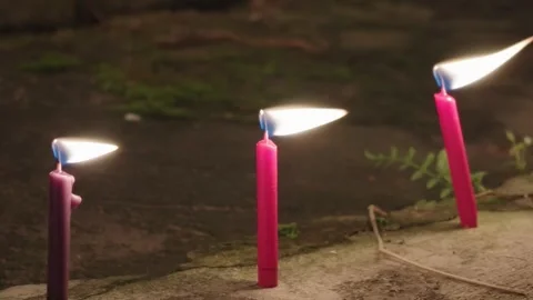 Three Red Burning Candles in Dark Outdoor Setting at Night Vídeo Stock 346520072