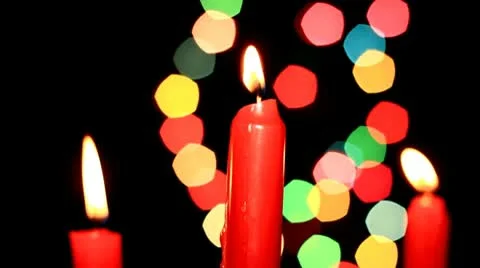 Three red candles on background of the color lights Stock Footage