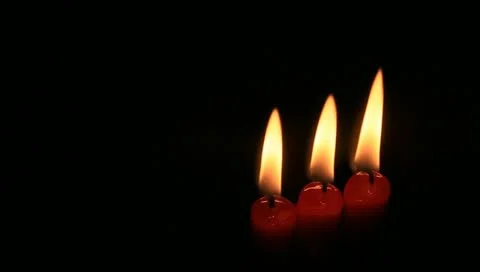 Three red candles on black Stock Footage 11022280