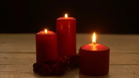Three red candles light with roses romantic theme Stock Footage 80811115
