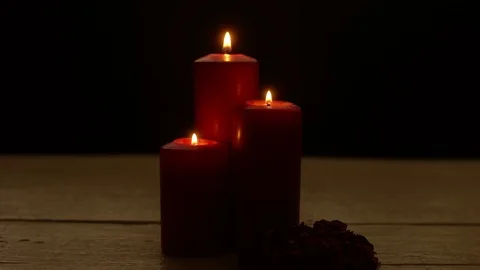 Three red candles lights with rose Stock Footage 85078806