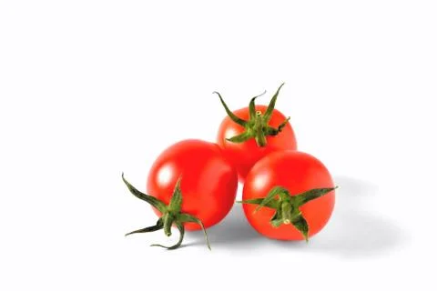 Three red cherry tomatoes with green leaves isolated on white background, iso Stock Photos
