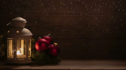 Three red Christmas balls  lantern with a burning candle and a fir branch on Stock Footage 68998736