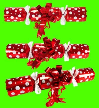 Three red christmas crackers keyed against green background Stock Photos