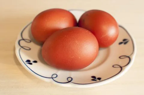 Three red-colored Easter eggs. Stock Photos