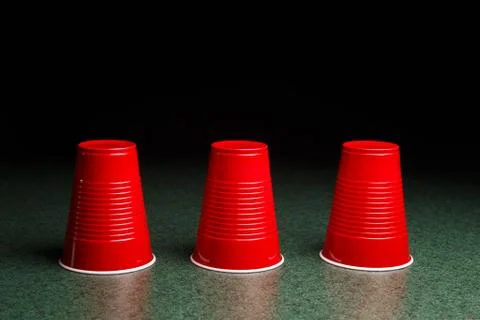 Three red cups - shell game Stock Photos