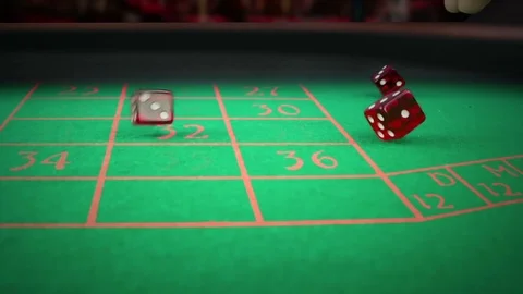 Three red dice rolling on green game gambling table on light disco, slow motion Video stock 80038504