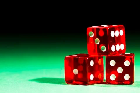 Three red dices on green Stock Photos