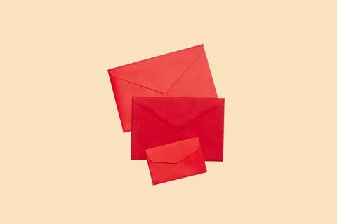 Three red envelopes on a beige background with copy space Stock Photos