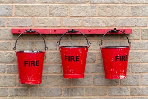Three red fire buckets Stock Photos