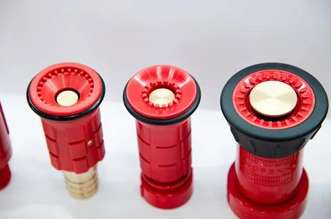 Three red fire hoses with brass caps Stock Photos