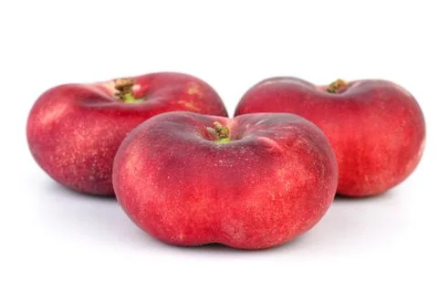 Three red flat peaches  isolated on the white background Stock Photos