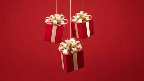 Three red gift boxes with golden ribbons swinging gently on a vibrant red b.. Stock Footage 327249509