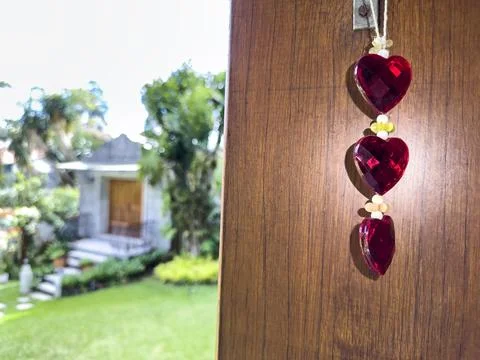 Three red hearts hanging. Stock Photos