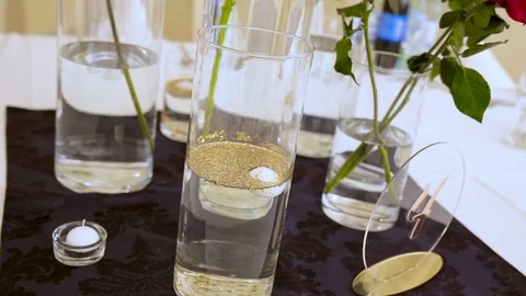 Three red lush roses in a vase on the table in a restaurant. Stock Footage 116975588