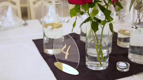 Three red lush roses in a vase on the table in a restaurant. Stock Footage 116975620