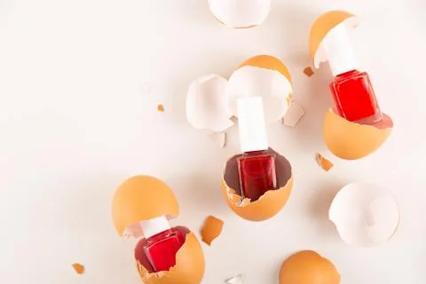 Three red nail polishes in eggshell on light background Stock Photos