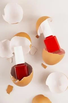 Three red nail polishes in eggshell on light background Stock Photos