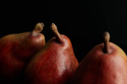 Three red pears on a black table Stock Photos
