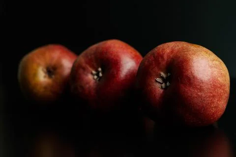 Three red pears on a black table Stock Photos
