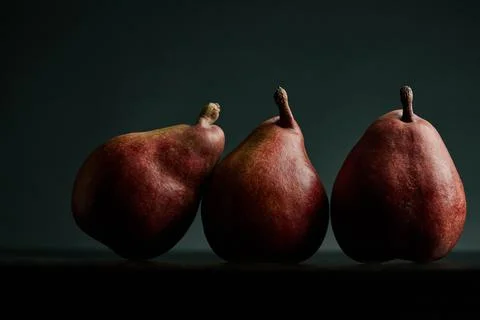 Three red pears on a black table Stock Photos