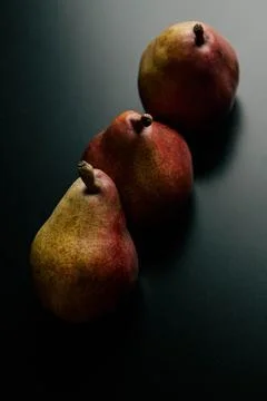 Three red pears on a black table Stock Photos