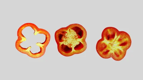 Three Red Pepper Slices Rotating on White Background in 60p Stock Footage 337682545