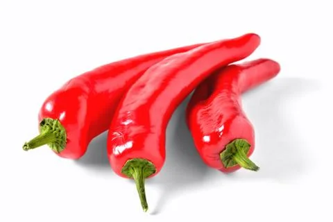 Three red peppers elongated shape on white background, isolate Stock Photos