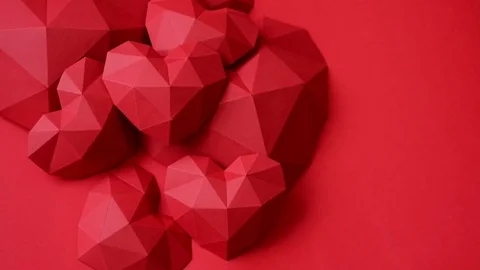 Three red polygonal paper heart shape over wooden bachground Stock Footage 72372792
