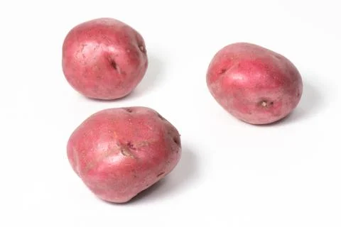 Three red potatoes on white Foto stock