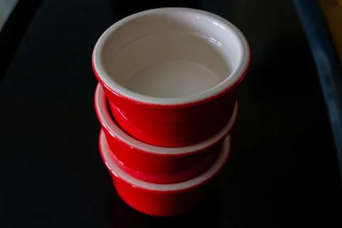 Three red ramekins stacked Stock Photos