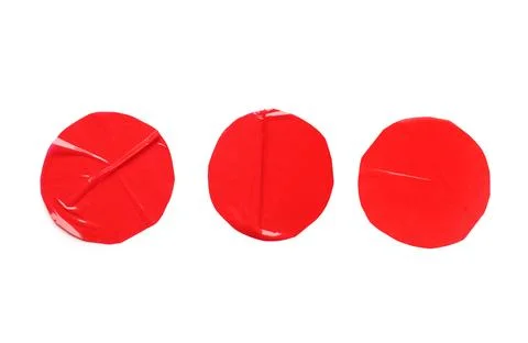 Three red round adhesive tape pieces with wrinkled texture, isolated on a cle Stock Photos