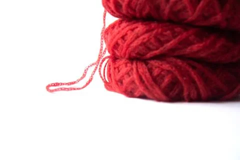 Three red tangles of delicate yarn isolated on white background Stock Photos