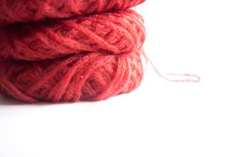 Three red tangles of delicate yarn isolated on white background Stock Photos